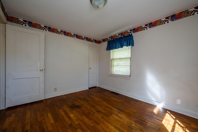 spare room featuring dark hardwood / wood-style flooring