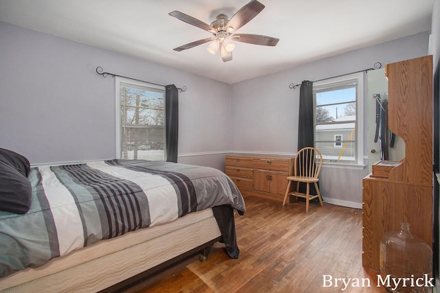 bedroom with ceiling fan and hardwood / wood-style floors