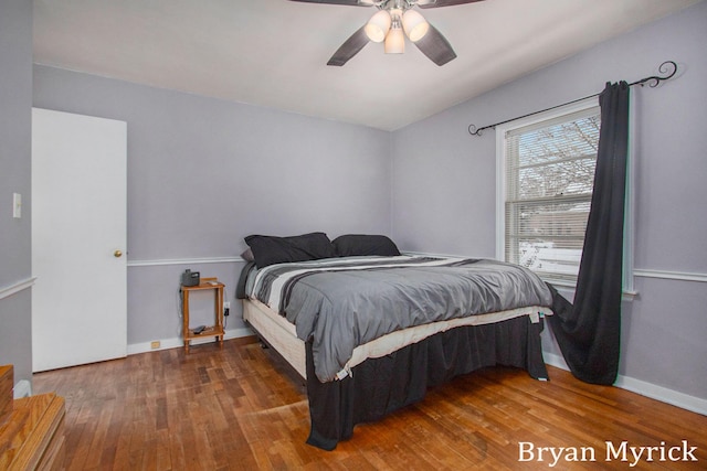 bedroom with ceiling fan and dark hardwood / wood-style flooring