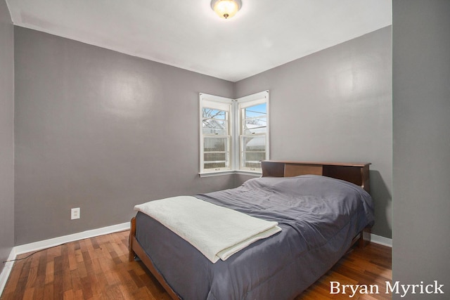 bedroom with dark wood-type flooring