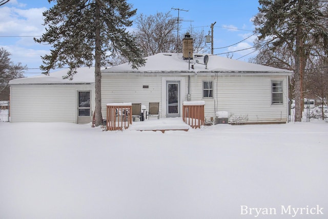 view of snow covered rear of property