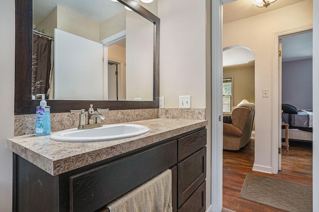 bathroom with hardwood / wood-style flooring and vanity