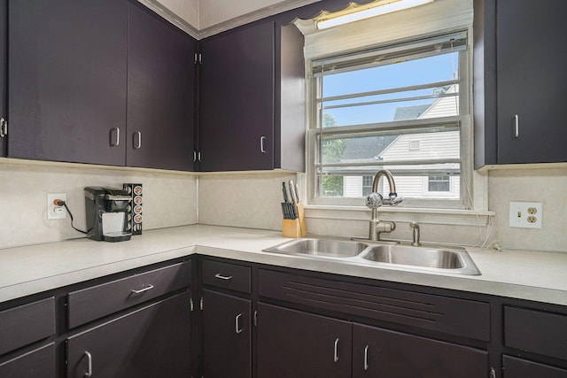 kitchen with a healthy amount of sunlight, decorative backsplash, and sink