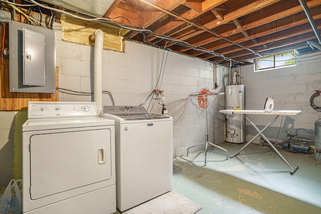 washroom with electric panel, gas water heater, and independent washer and dryer