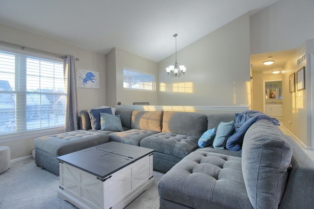 carpeted living room featuring plenty of natural light, vaulted ceiling, and a notable chandelier