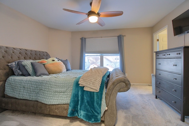 bedroom featuring ceiling fan and light carpet