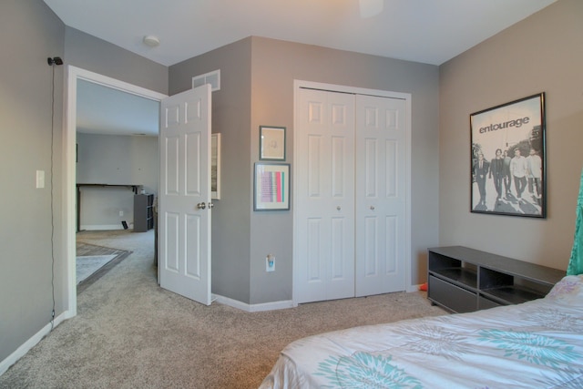 bedroom with light carpet and a closet