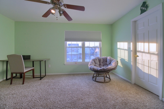 living area with light carpet and ceiling fan