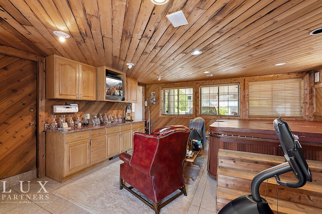 interior space with light tile patterned floors, wood ceiling, and wooden walls