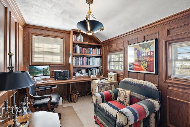 office space with built in shelves, wood walls, a healthy amount of sunlight, and ornamental molding