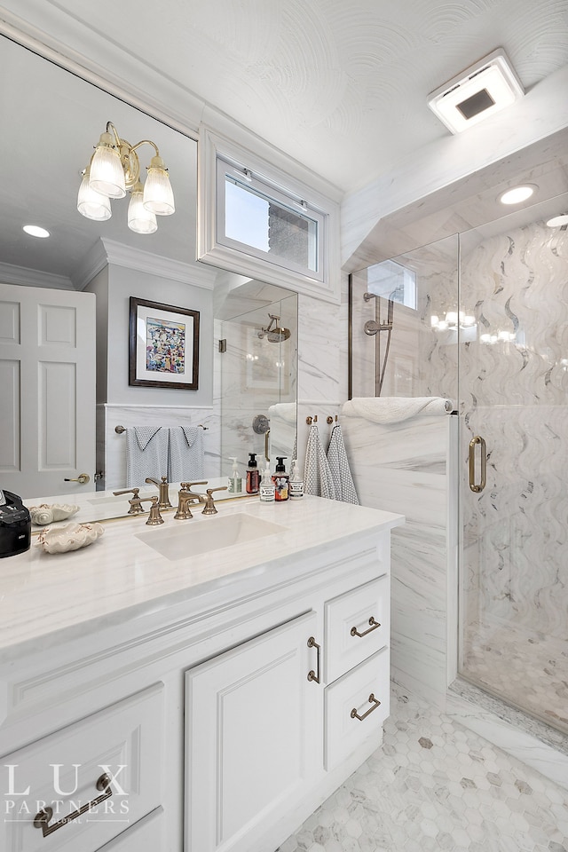 bathroom with vanity, tile walls, and a shower with door