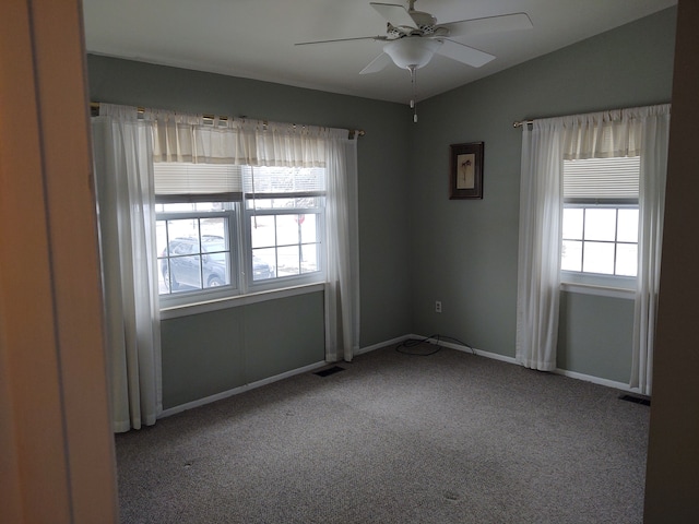 carpeted spare room with ceiling fan and a healthy amount of sunlight