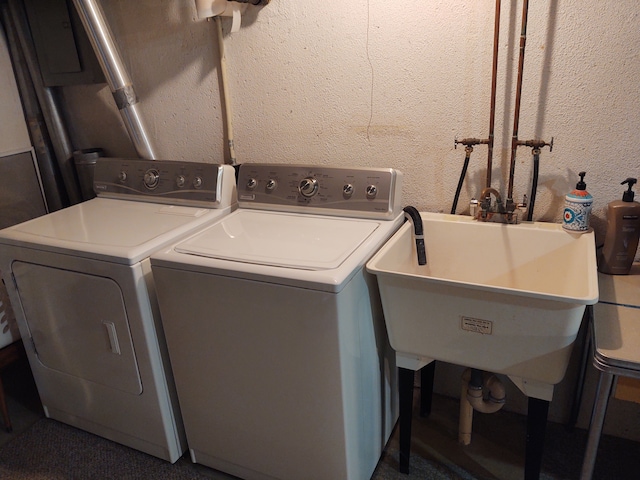 washroom with washer and dryer and sink