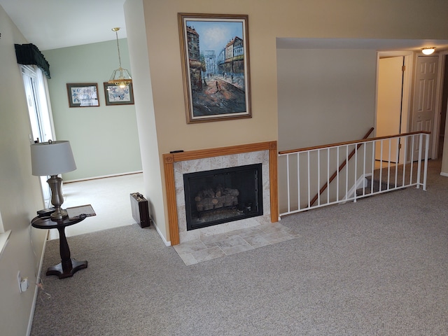 unfurnished living room with a tile fireplace and light carpet