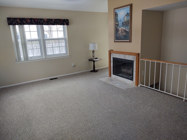 unfurnished living room with light carpet and a fireplace