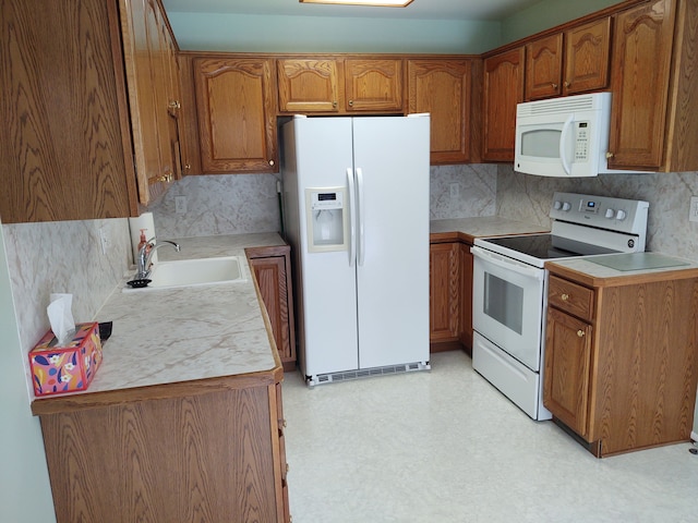 kitchen with decorative backsplash, sink, and white appliances