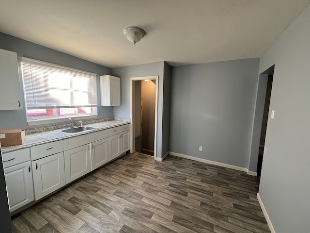 kitchen with sink, white cabinetry, and dark hardwood / wood-style flooring