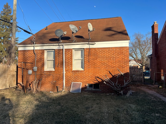 rear view of property with a lawn