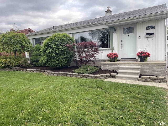 ranch-style house with a front lawn