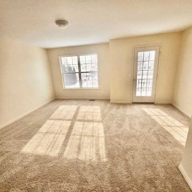 13319 St Ervin Ave Unit 17, Detroit, MI 48215 - unfurnished room with a wealth of natural light, light colored carpet, and baseboards