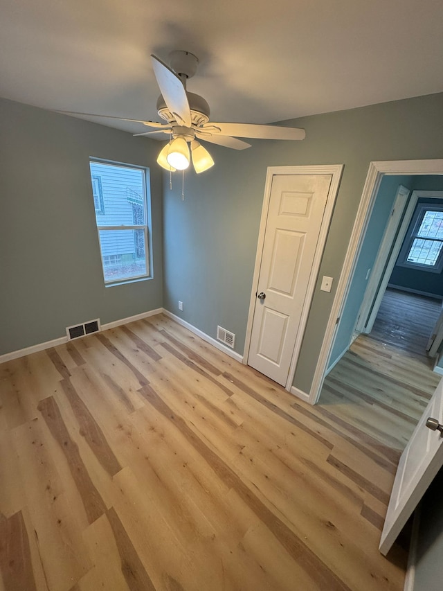 unfurnished bedroom with ceiling fan and light hardwood / wood-style flooring