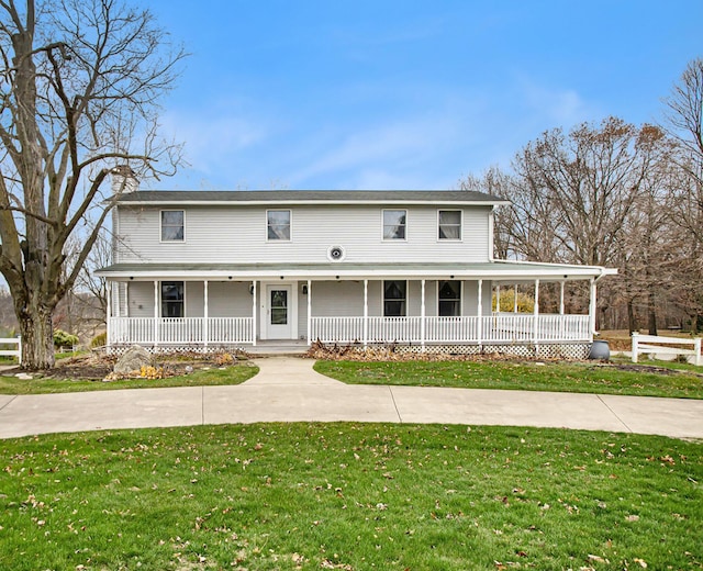 country-style home featuring a front yard and a porch