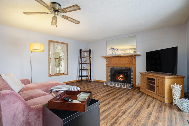 living room with ceiling fan, wood-type flooring, and a fireplace