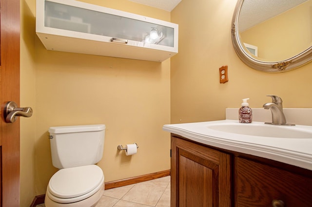 bathroom featuring a textured ceiling, tile patterned floors, vanity, and toilet