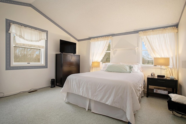 carpeted bedroom featuring crown molding and lofted ceiling