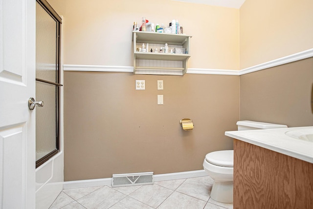 full bathroom with tile patterned floors, enclosed tub / shower combo, vanity, and toilet