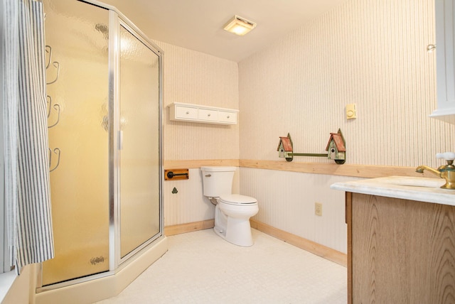 bathroom with toilet, walk in shower, and vanity