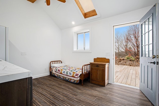 bedroom with dark wood-type flooring, ceiling fan, and vaulted ceiling with skylight