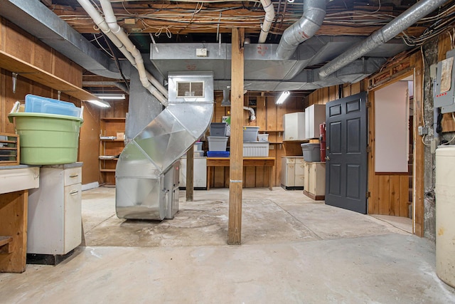 basement featuring wooden walls