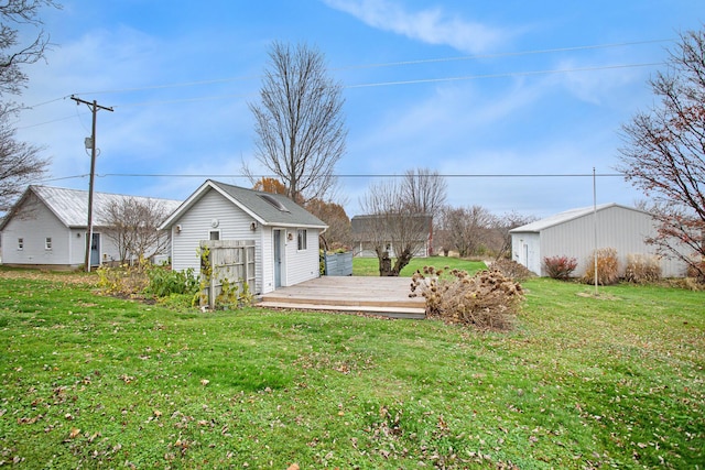 view of yard featuring a deck and an outdoor structure