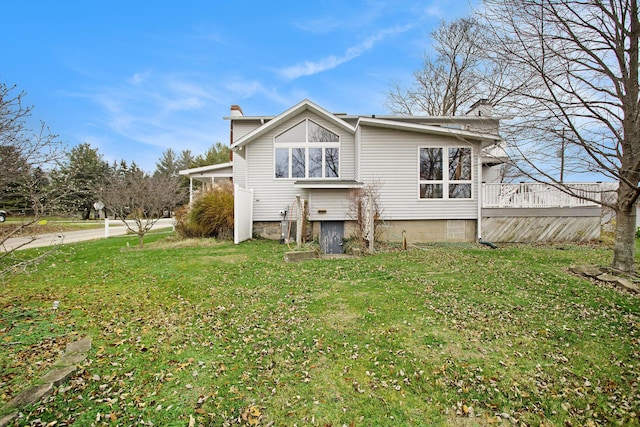 back of house featuring a yard