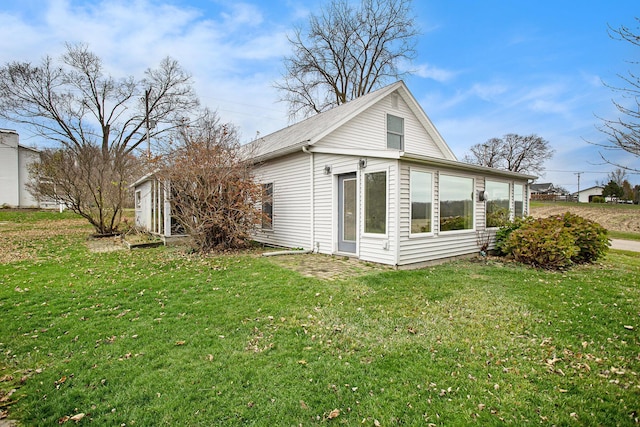 view of home's exterior with a lawn