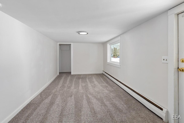 unfurnished room featuring light carpet and baseboard heating