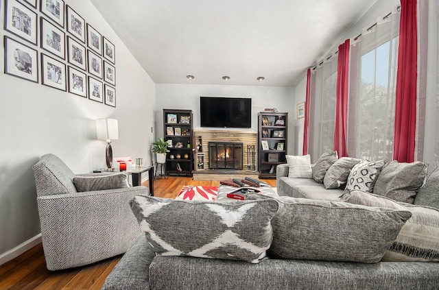 living room with hardwood / wood-style flooring and a fireplace