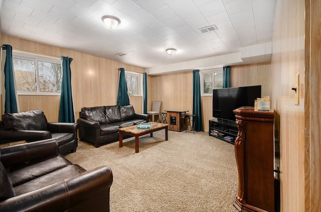 living room featuring light carpet and wooden walls