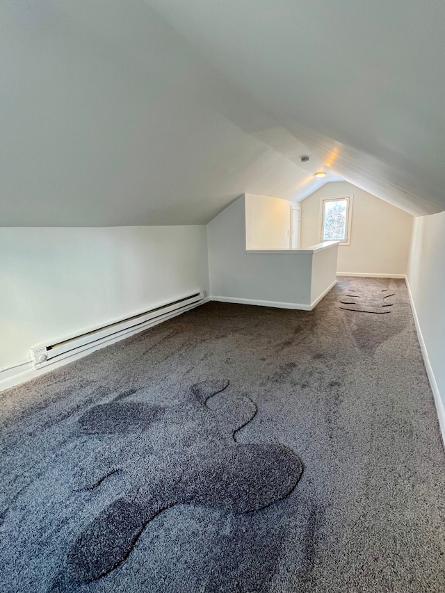 additional living space featuring vaulted ceiling, carpet, and a baseboard radiator