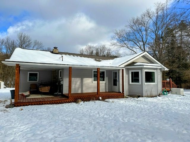 snow covered property featuring a porch