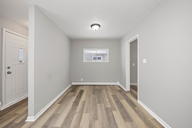 interior space featuring wood-type flooring and a baseboard radiator