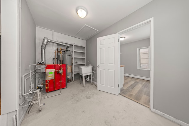 basement featuring baseboard heating and gas water heater