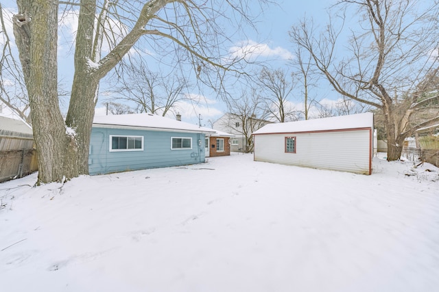 view of snow covered rear of property