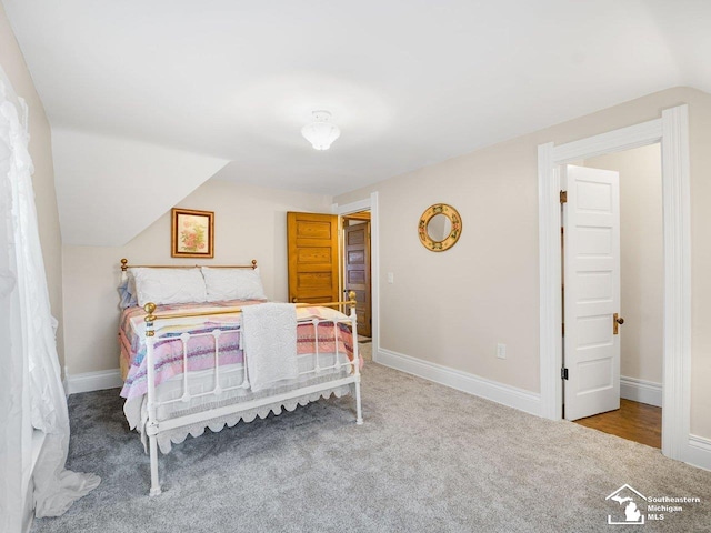 bedroom with lofted ceiling and carpet