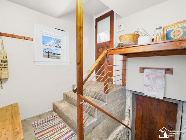 stairs featuring concrete flooring