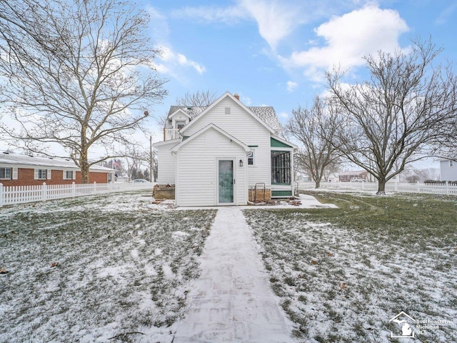 view of snow covered back of property