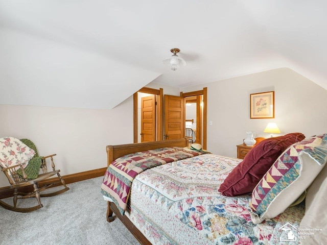 bedroom featuring carpet floors and vaulted ceiling