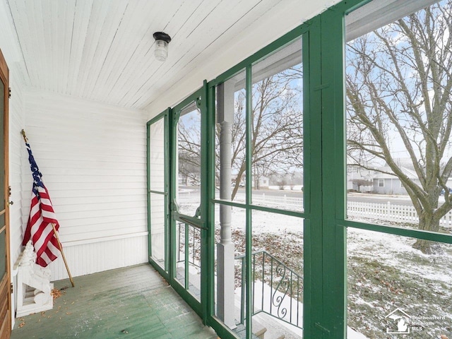 unfurnished sunroom with wooden ceiling