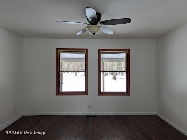 unfurnished room with ceiling fan and dark hardwood / wood-style flooring